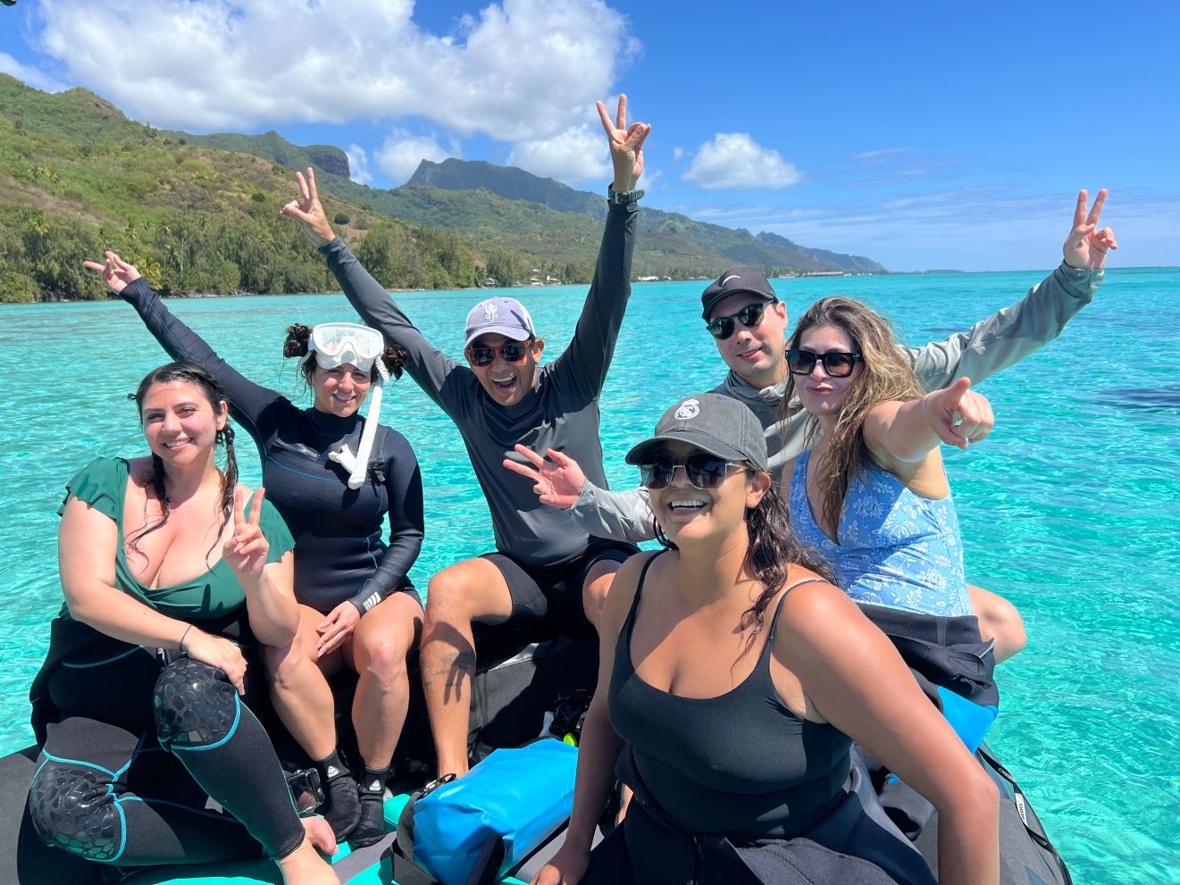 Smiling group on a boat in the Moorea lagoon.