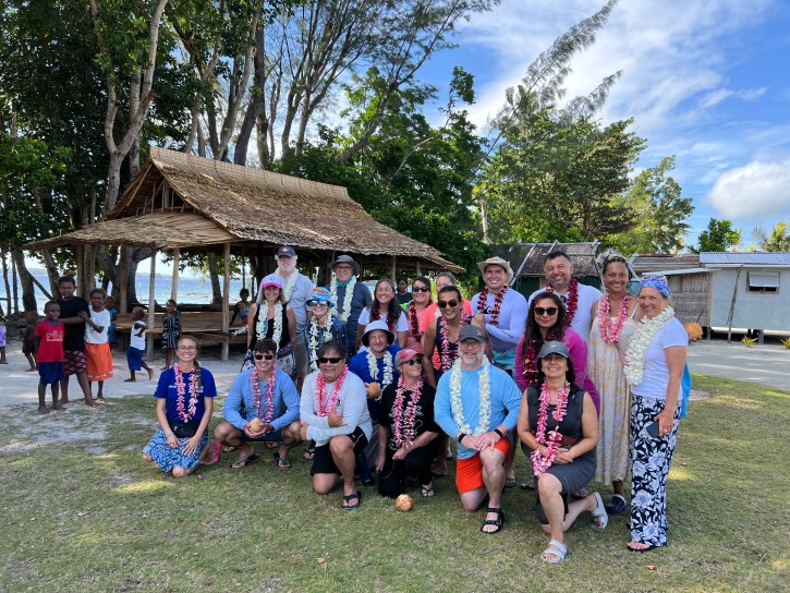 Group photo with the village chief and community at the welcome ceremony