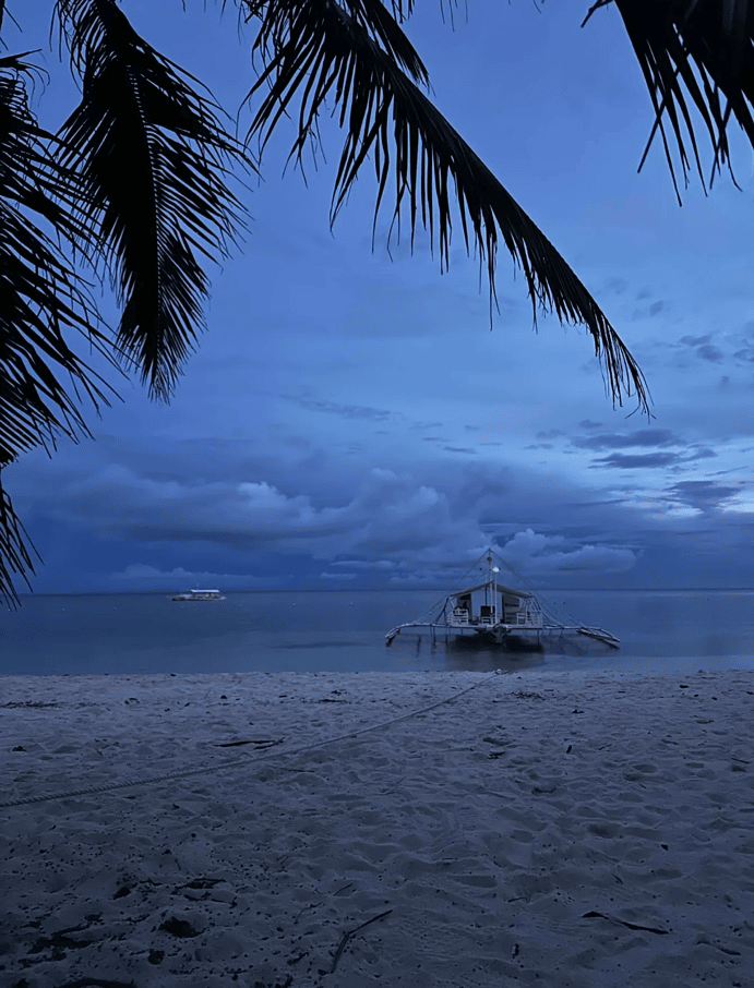 Tropical beach and traditional boat at Amun Ini