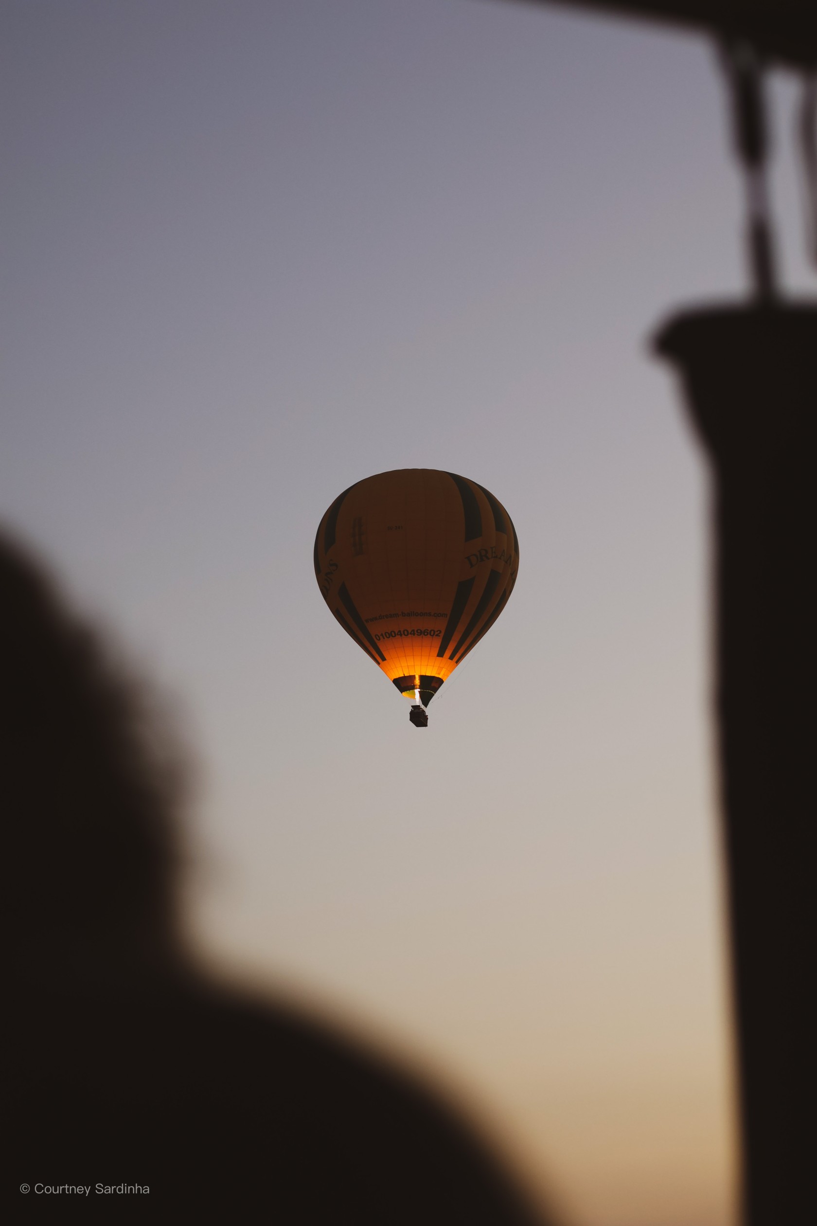 A hot air balloon in the early morning sky over Luxor, Egypt