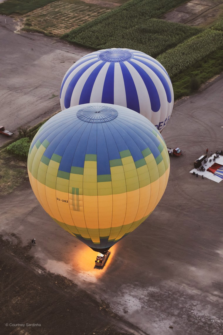 Aerial view of hot air balloons launching over the fields of Luxor, Egypt