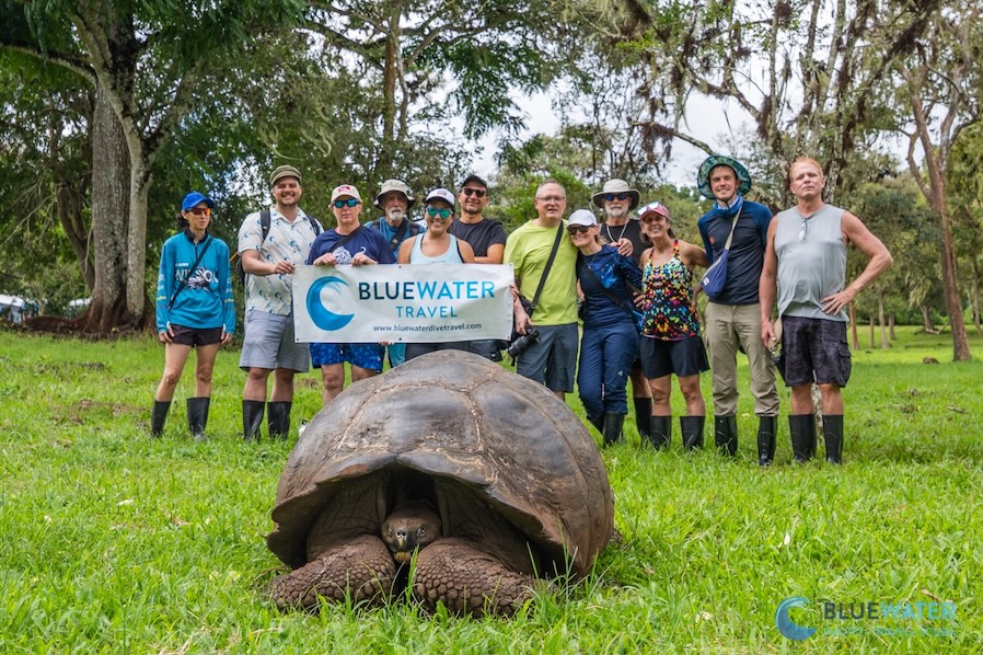 Happy Bluewater guests pose with a Galapagos giant tortoise