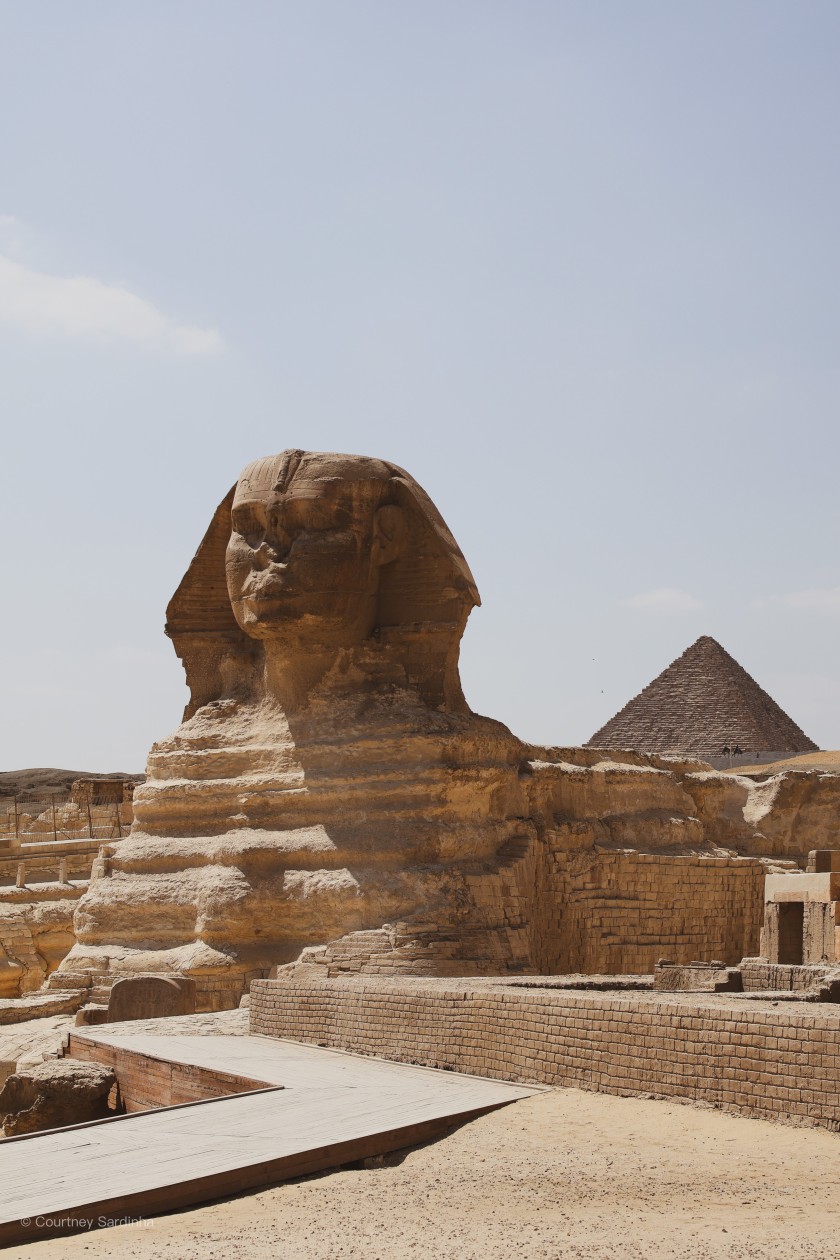 The Great Sphinx of Giza with a pyramid in the background, Cairo, Egypt