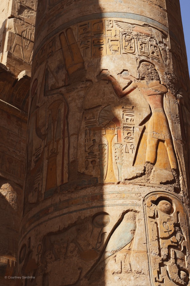 Colorful hieroglyphic carvings on a column at Karnak Temple, Luxor, Egypt