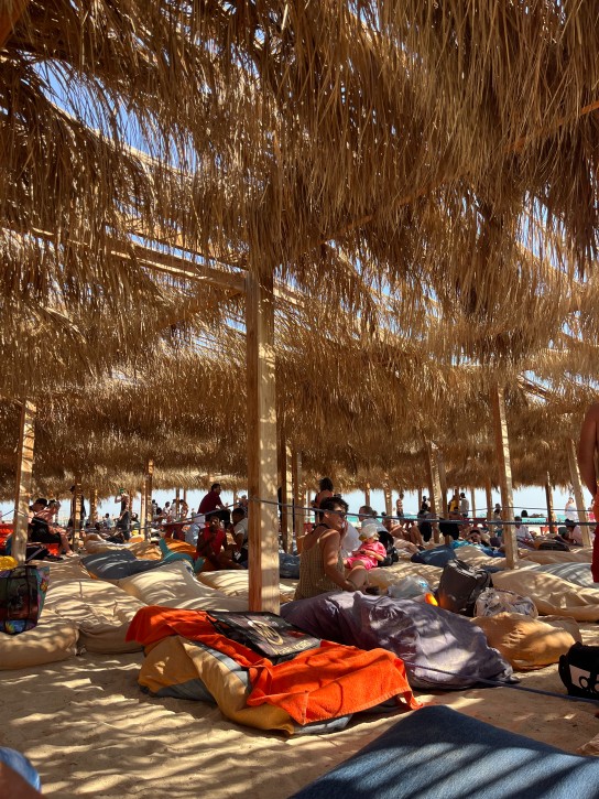 Beach club with straw umbrellas and sunbeds in Hurghada, Egypt