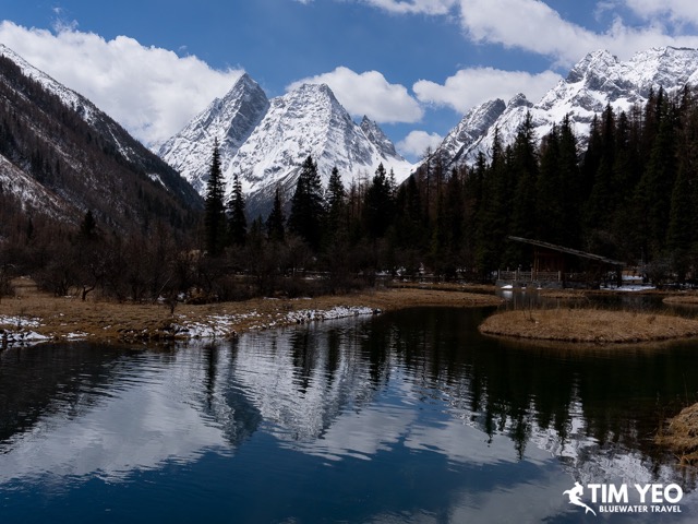 A lake with snowcapped peaks in the background